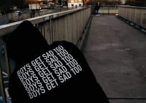A hoodie that reads "Boys get sad too." Help is available. You don't have to go through this alone. 